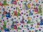 Preview: Patchworkstoff von RJR mit vielen bunten Dinos auf weißem Untergrund.