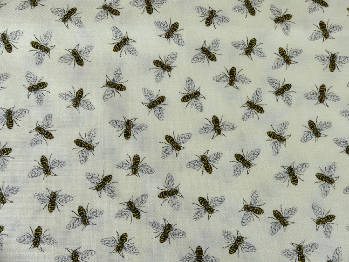Patchworkstoff, cremefarbig mit kleinen schwarzen Bienen. Meterware.